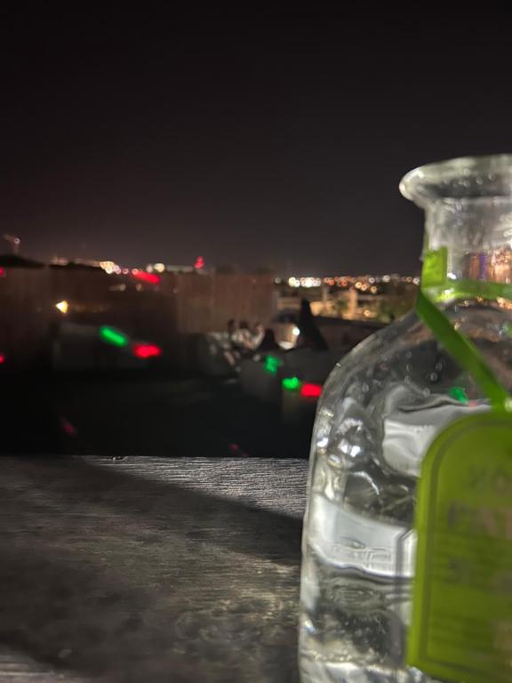 a bottle of water sitting on a table at night at Roof top glamping and Toys suites in Eilat