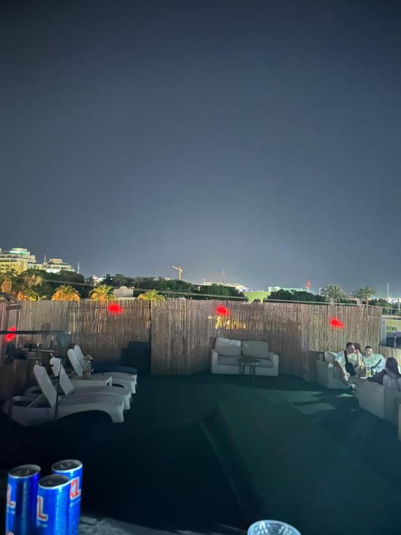 a living room with couches and chairs on a roof at Roof top glamping and Toys suites in Eilat