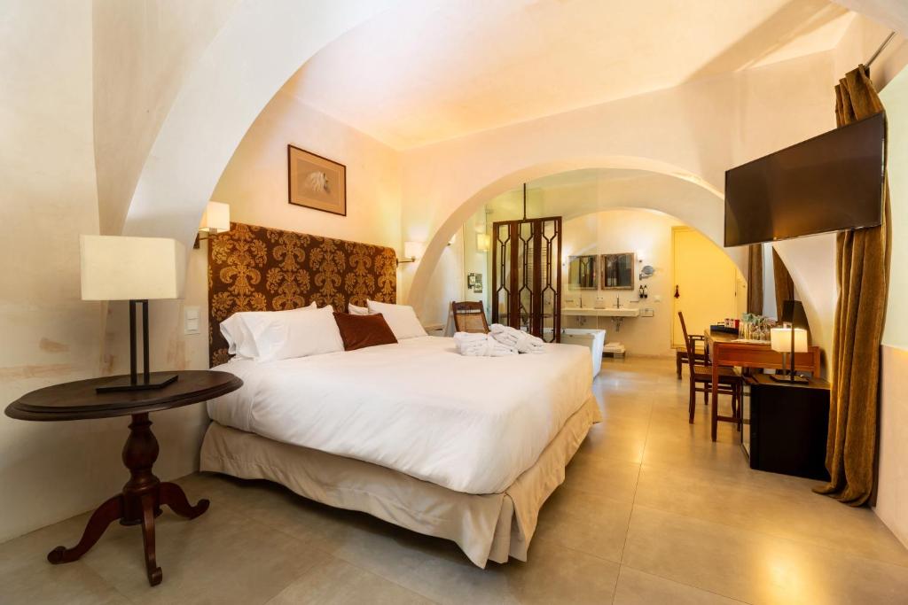 Een bed of bedden in een kamer bij Hotel Boutique V