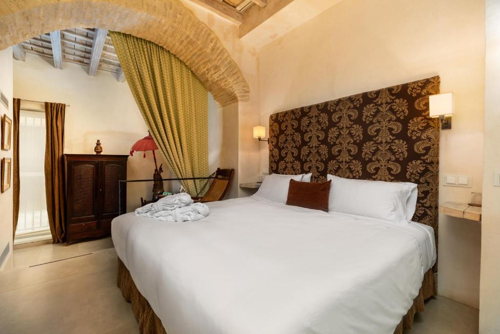 Een bed of bedden in een kamer bij Hotel Boutique V