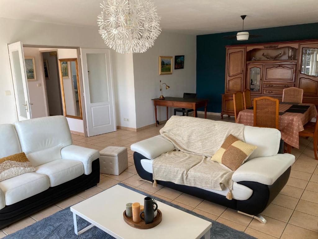 a living room with a couch and a table at Belle maison sur la Voie Verte, Mâcon-Cluny, 6 personnes in Charnay-lès-Mâcon