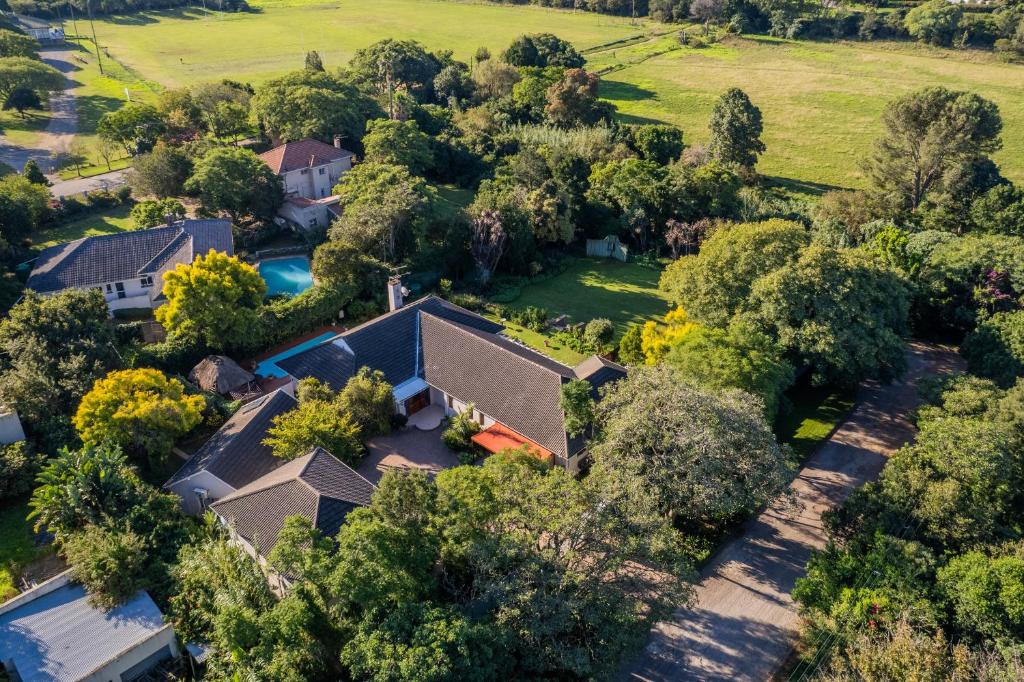 an aerial view of a house with a pool and trees at 1 on Ross in Grahamstown