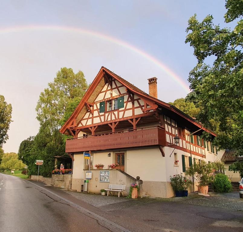 a house with a rainbow in the sky at Studio beim Rhein - Ziegelhütte in Flaach