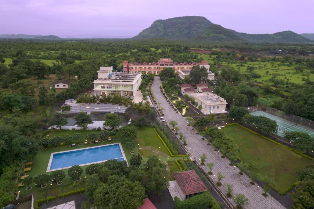 an aerial view of a mansion with a swimming pool at juSTa Rudra Resort & Spa in Kolād