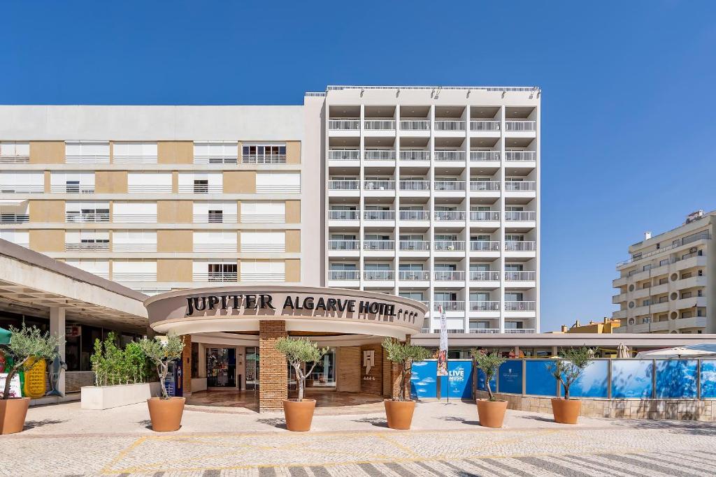 a building with a sign that reads hunter alliance hotel at Jupiter Algarve Hotel in Portimão