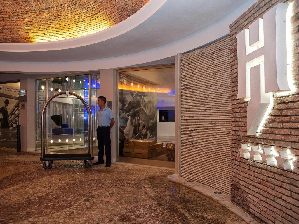 a man standing in front of a store at Jupiter Algarve Hotel in Portimão