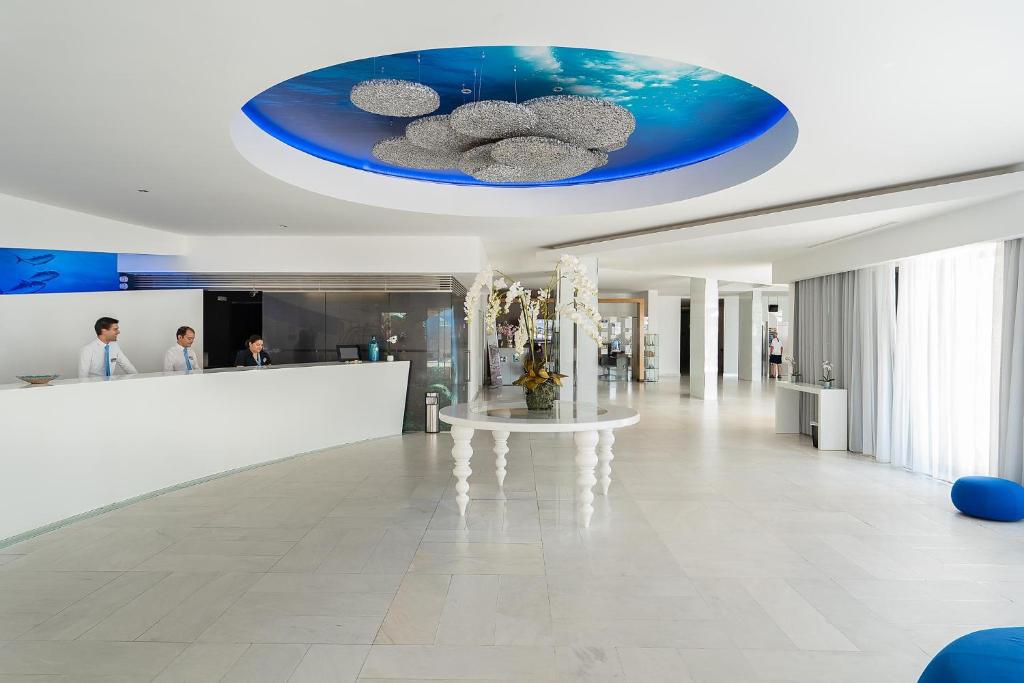 a lobby of a building with a blue ceiling at Jupiter Algarve Hotel in Portimão