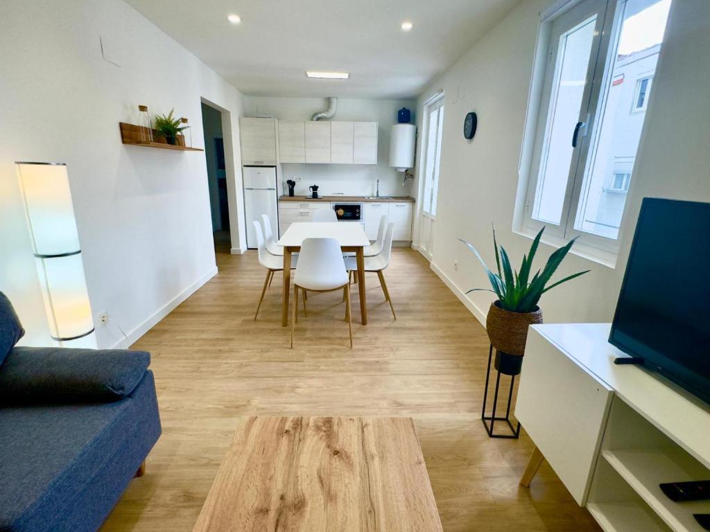 a living room with a table and a kitchen at bcool in Bilbao
