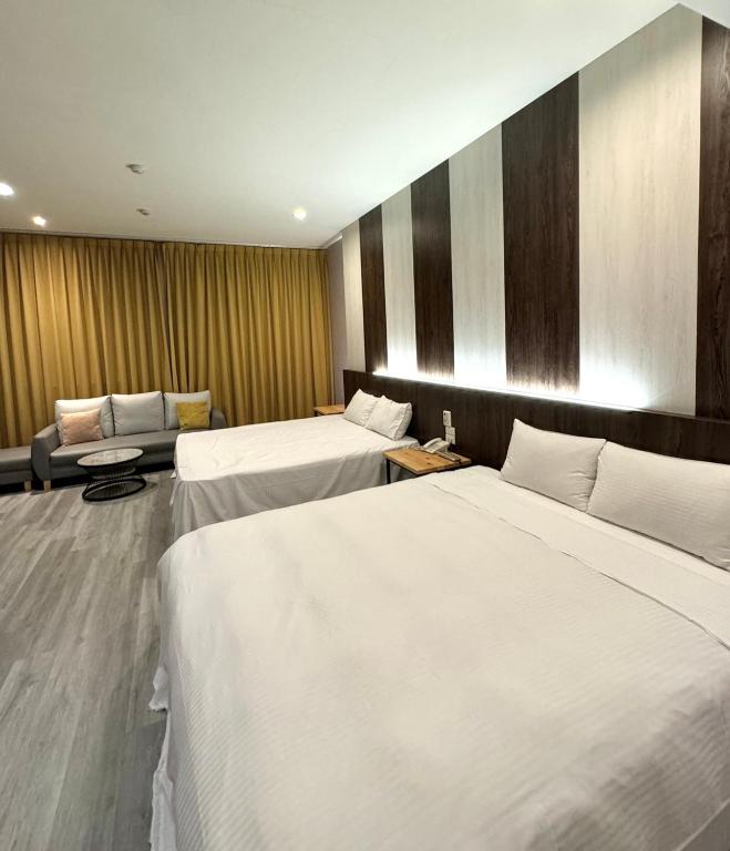 Postel nebo postele na pokoji v ubytování Her Home Spa Motel Douliu