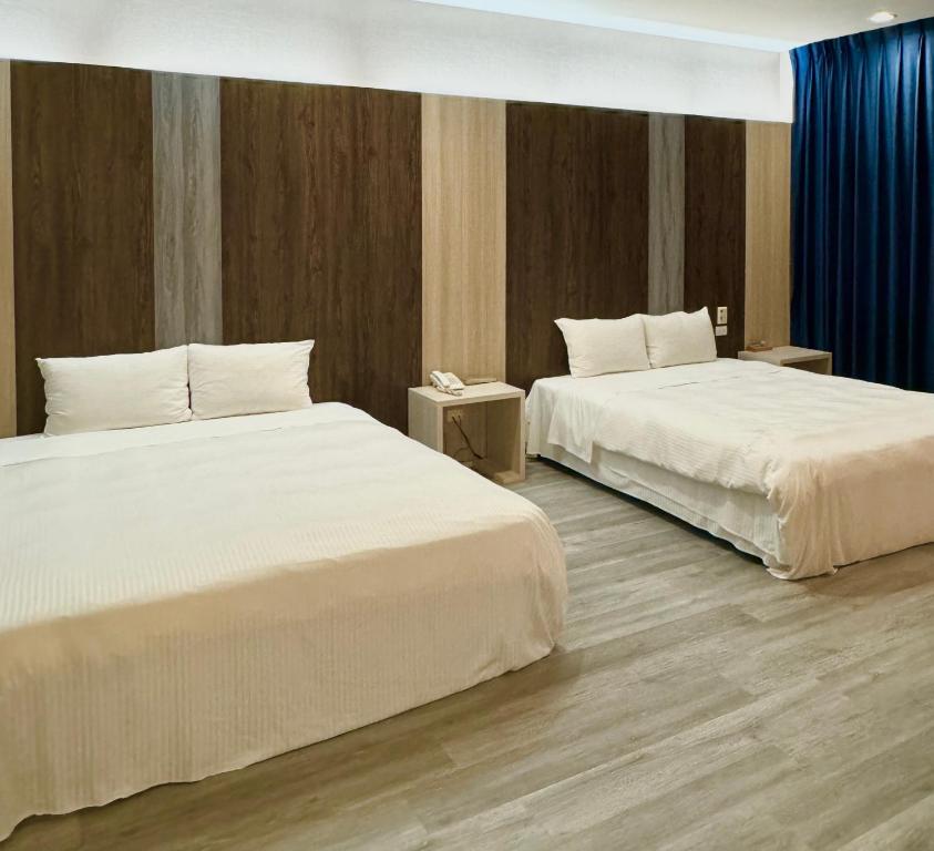 Postel nebo postele na pokoji v ubytování Her Home Spa Motel Douliu