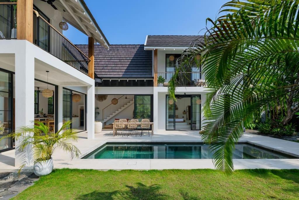 a house with a swimming pool in front of it at Terrene Villa in Weligama