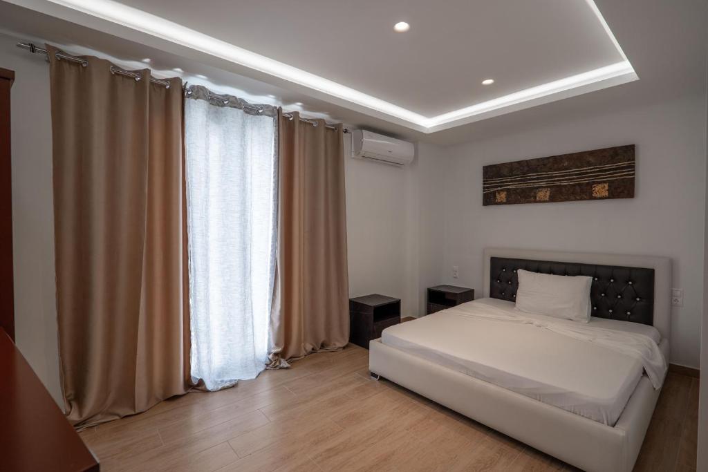ein Schlafzimmer mit einem weißen Bett und einem Fenster in der Unterkunft Fori's rooms in Himarë