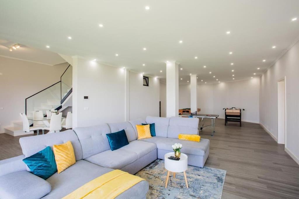 a living room with a blue couch and a table at Pena View Villa in Santa Cruz