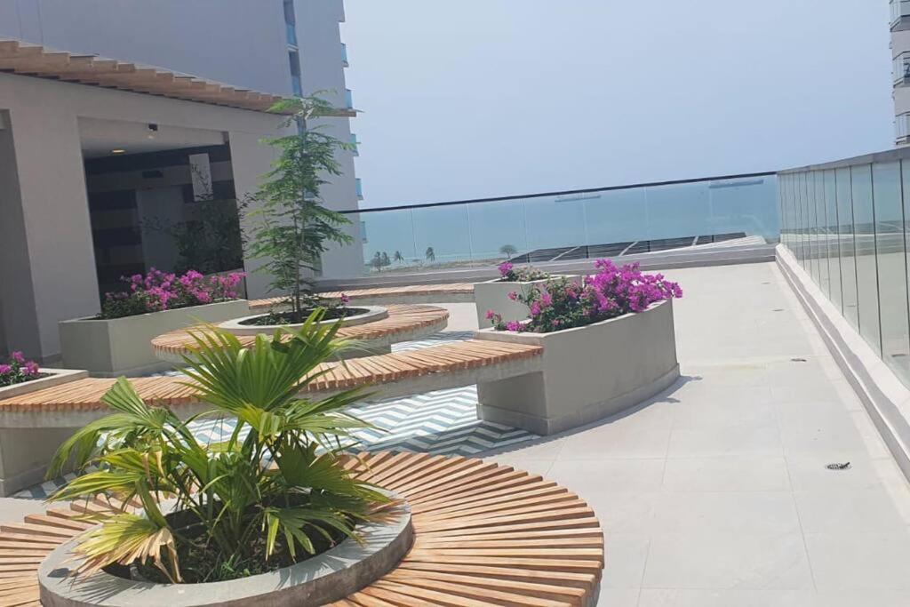 a balcony with benches and plants on a building at Apartaestudio en Pozos Colorados in Playa Bello Horizonte