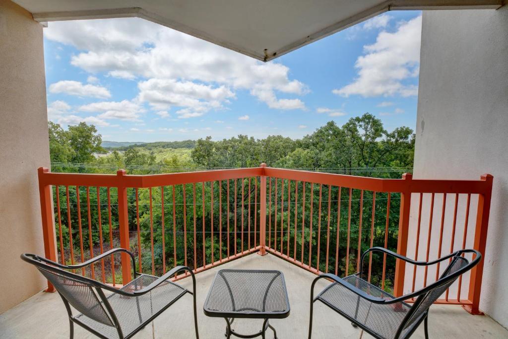 two chairs sitting on a balcony with a view at Grand Crowne Resort by Capital Vacations in Branson