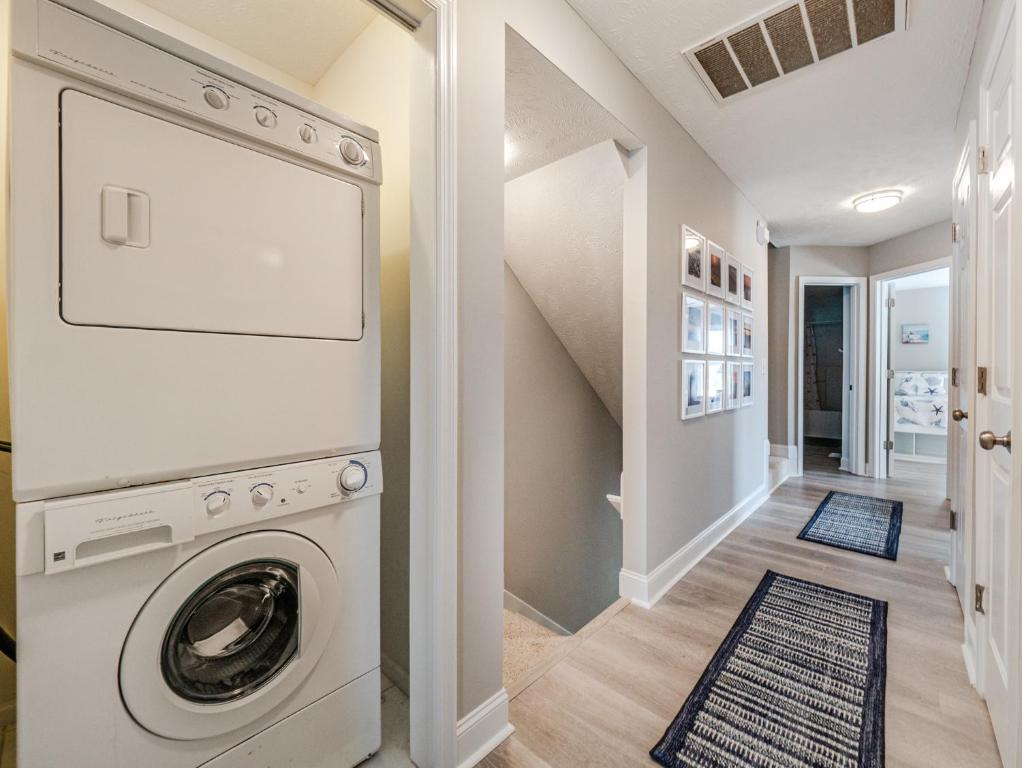 a laundry room with a washer and dryer at HypNautical in Surf City