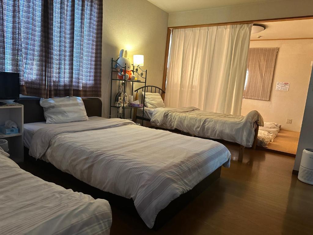 מיטה או מיטות בחדר ב-Private Inn Bambee