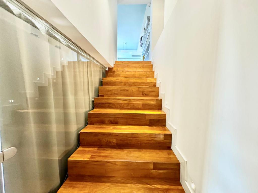 a staircase with wooden floors and white walls at La Gaetana in Gaeta