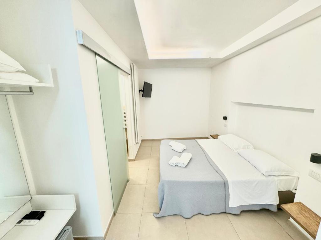 a white room with a bed and a window at La Gaetana in Gaeta