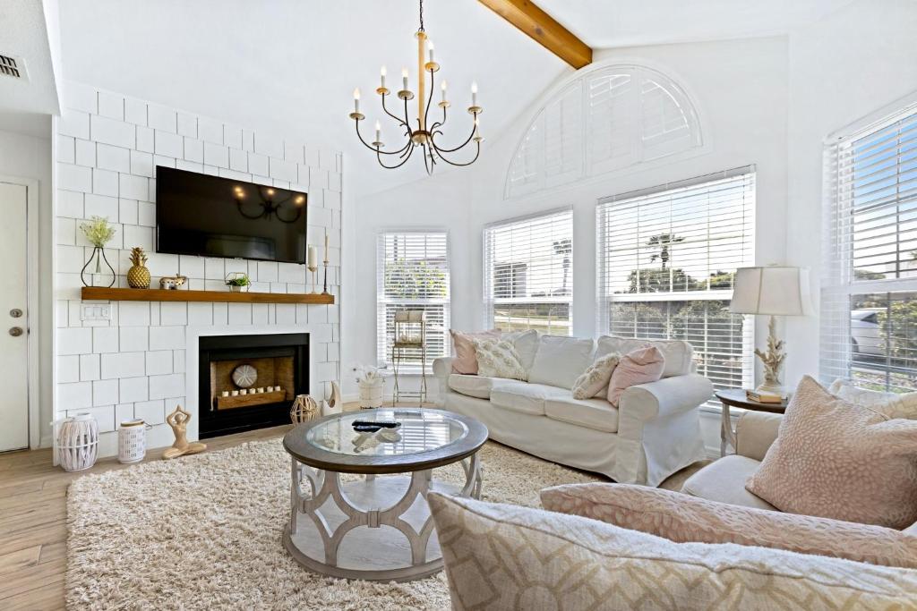 a living room with a couch and a fireplace at Beachside Elegance: Pool Spa Luxury Retreat Sun Beach Club 888 in Edgewater