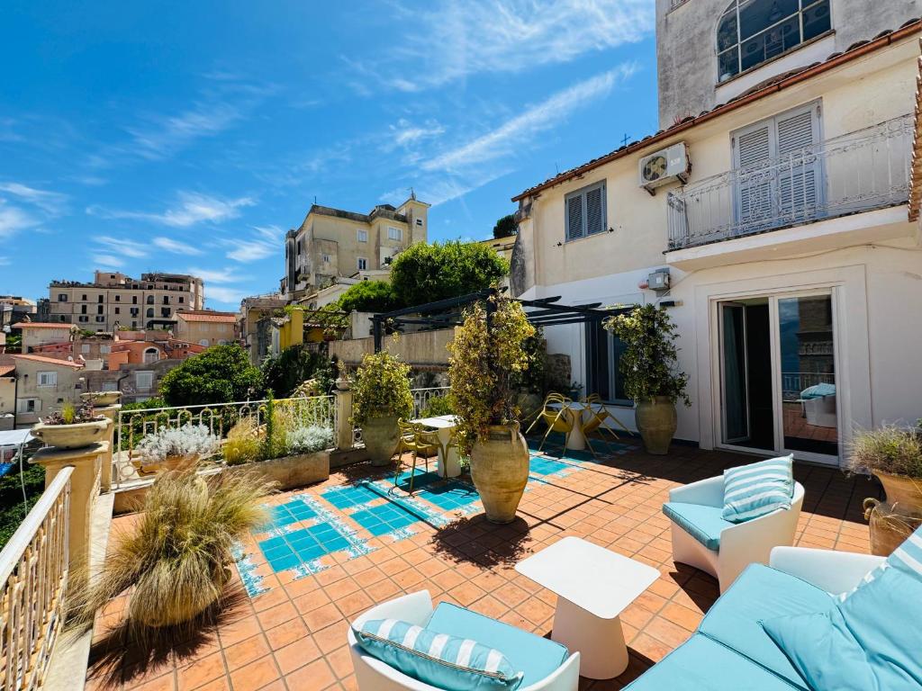 a patio with blue furniture on a building at La Gaetana in Gaeta
