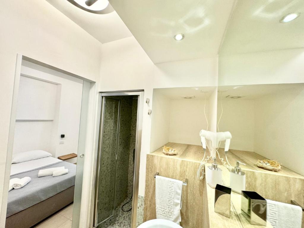 a bedroom with a mirror and a bed in a room at La Gaetana in Gaeta