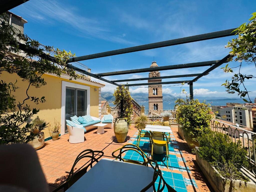 a patio with a clock tower in the background at La Gaetana in Gaeta