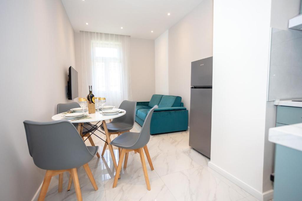 a small kitchen with a table and chairs in a room at Apartment Kjara in Herceg-Novi