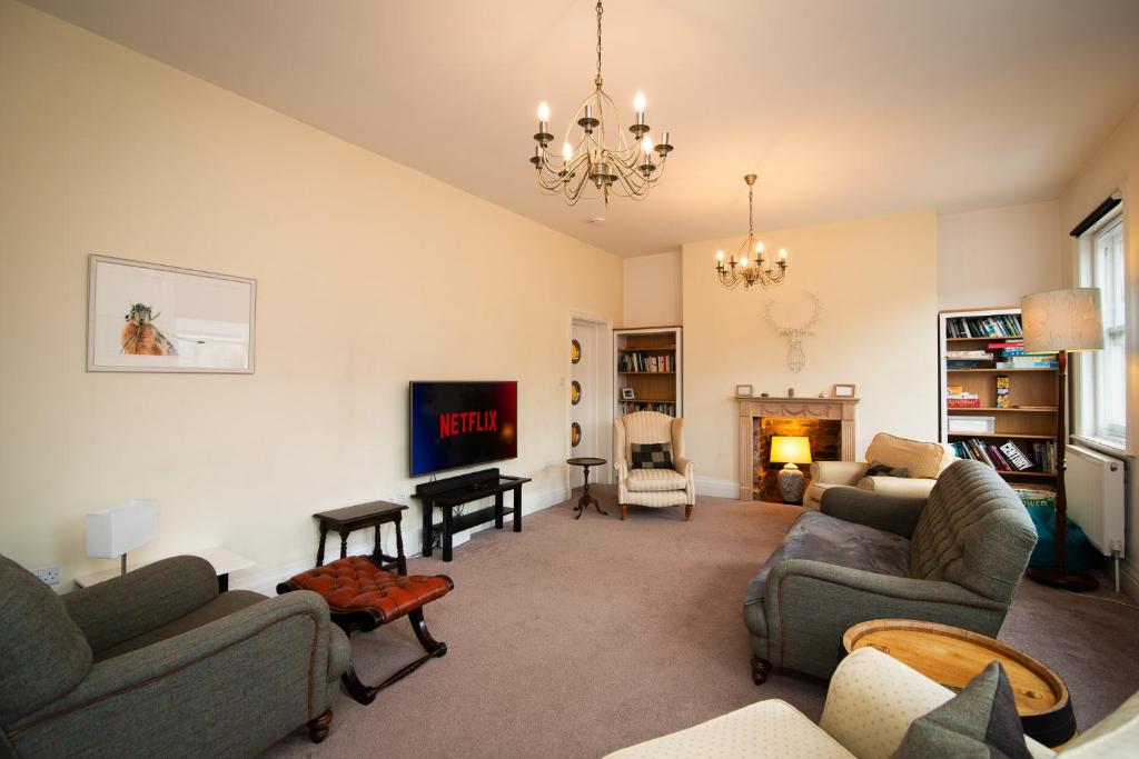 un salon avec deux canapés et une cheminée dans l'établissement 4 Bedroom Apartment in Central Matlock with River Views, à Matlock