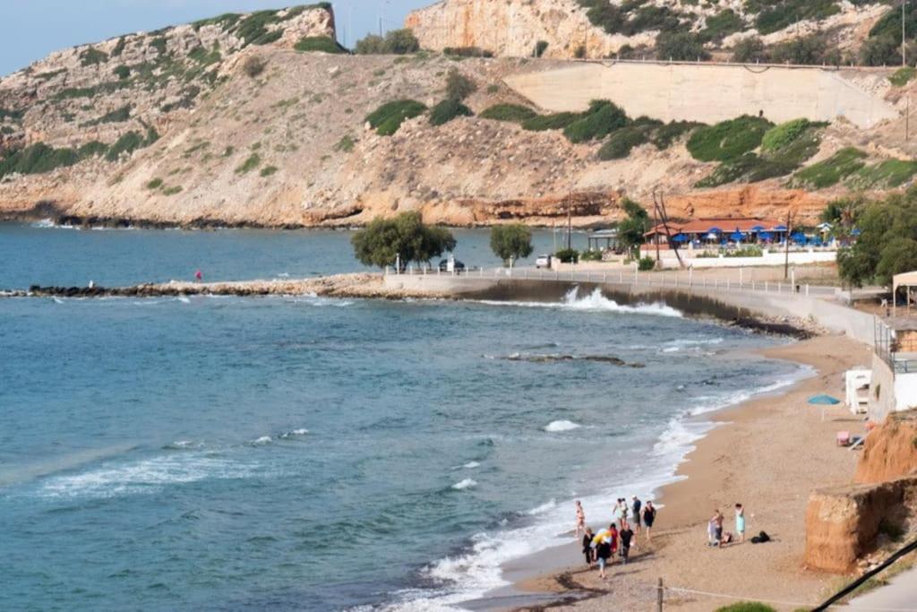 a group of people on a beach near the water at Ammos Beach Apartment in Skaleta
