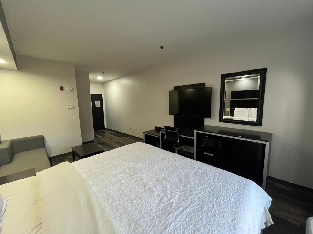 sypialnia z białym łóżkiem i telewizorem w obiekcie Econo lodge Kennett w mieście Kennett