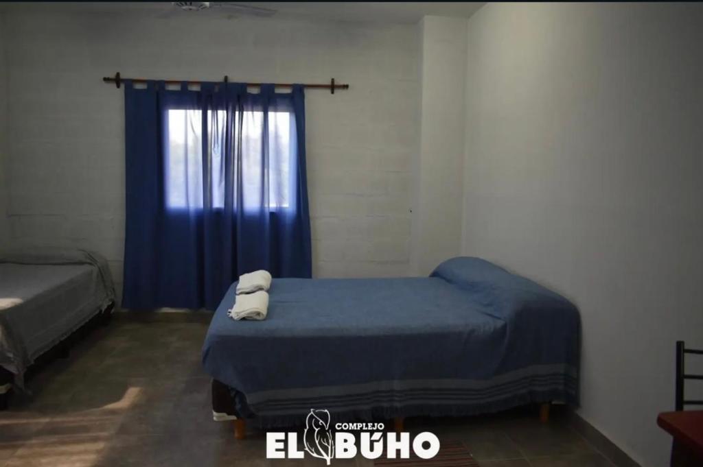Ένα ή περισσότερα κρεβάτια σε δωμάτιο στο Complejo el Buho 1