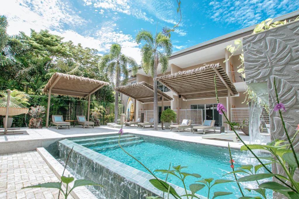 an image of a house with a swimming pool at Tamarindo Bay Boutique Hotel, Apartments & Suites in Tamarindo
