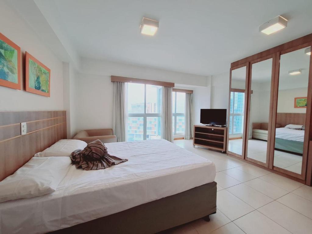 a bedroom with a large bed and a television at Saint Moritz Brasília - Flat Particular 704 - com Garagem in Brasilia
