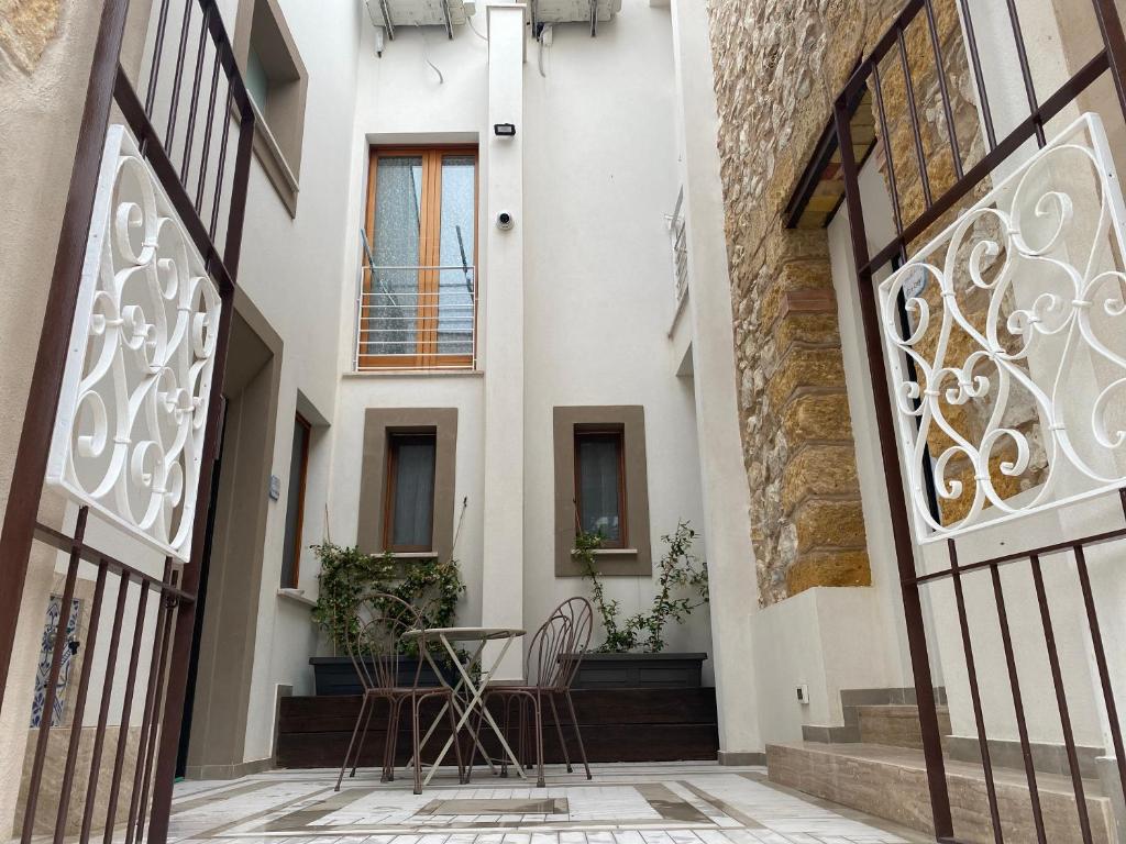 an internal courtyard of a house with a table and chairs at Tenute Plaia Agriturismo in Scopello