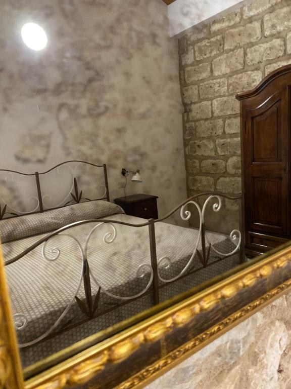 a bedroom with a bed and a mirror at Tenute Plaia Agriturismo in Scopello