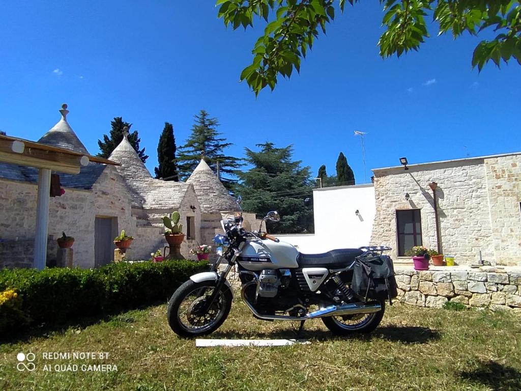 una moto parcheggiata di fronte a una casa di Nidadi Trulli d'Itria a Martina Franca