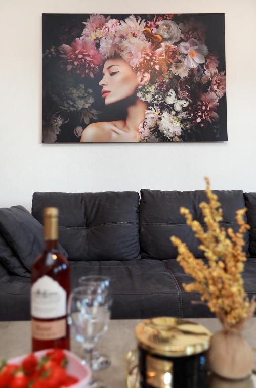 a bottle of wine on a table next to a couch at New,Modern apartment near Split andTrogir in Kaštela