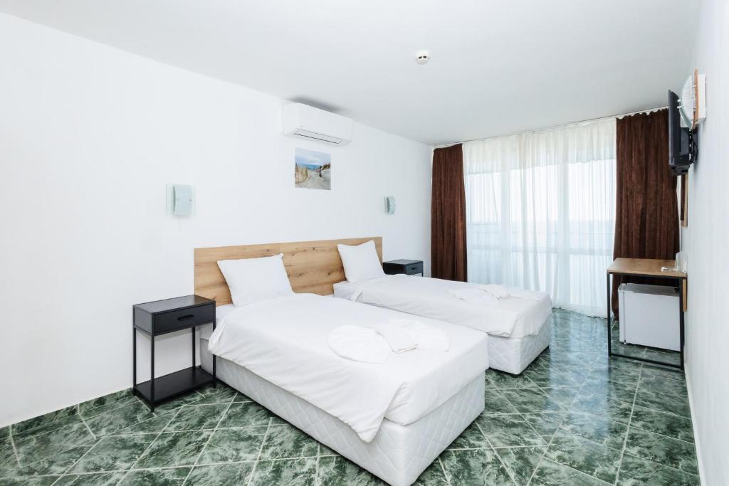 Postel nebo postele na pokoji v ubytování Hotel Arsenal