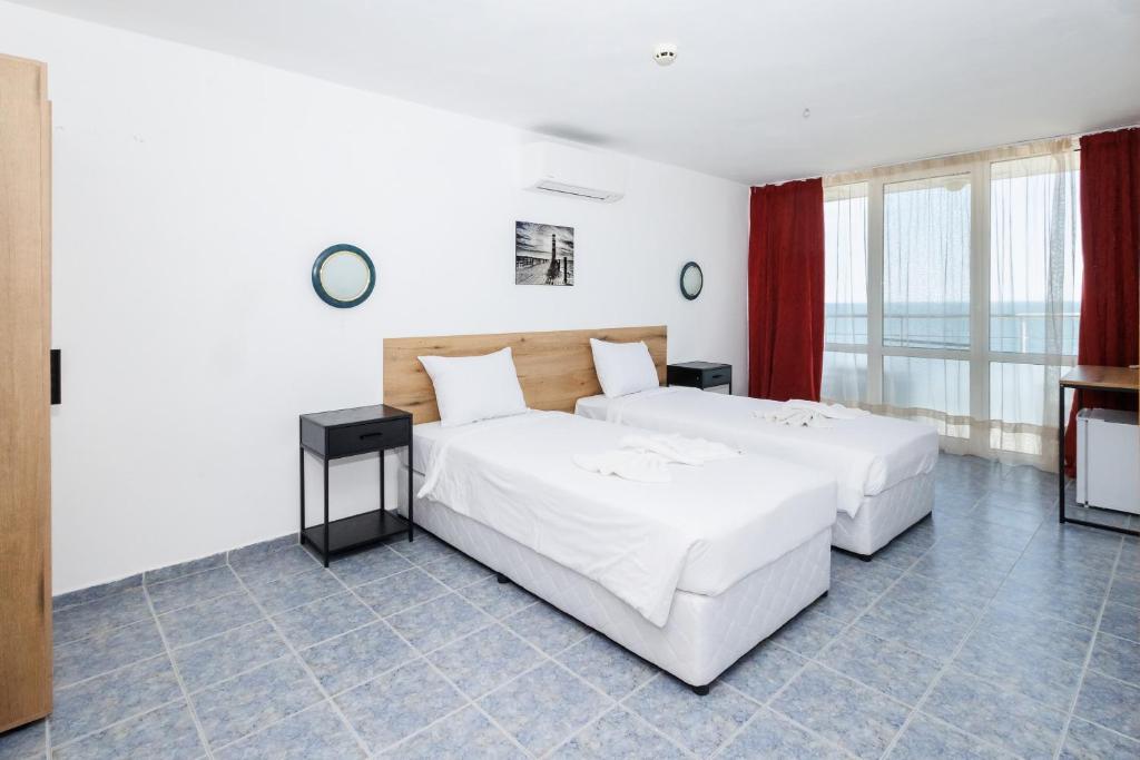Postel nebo postele na pokoji v ubytování Hotel Arsenal