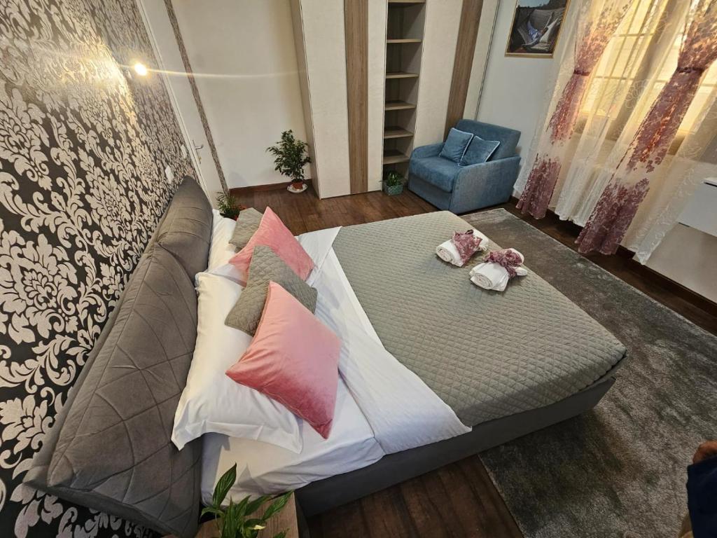 a bed with pillows on it in a room at Grande Bellezza Luxury Suite in Mestre