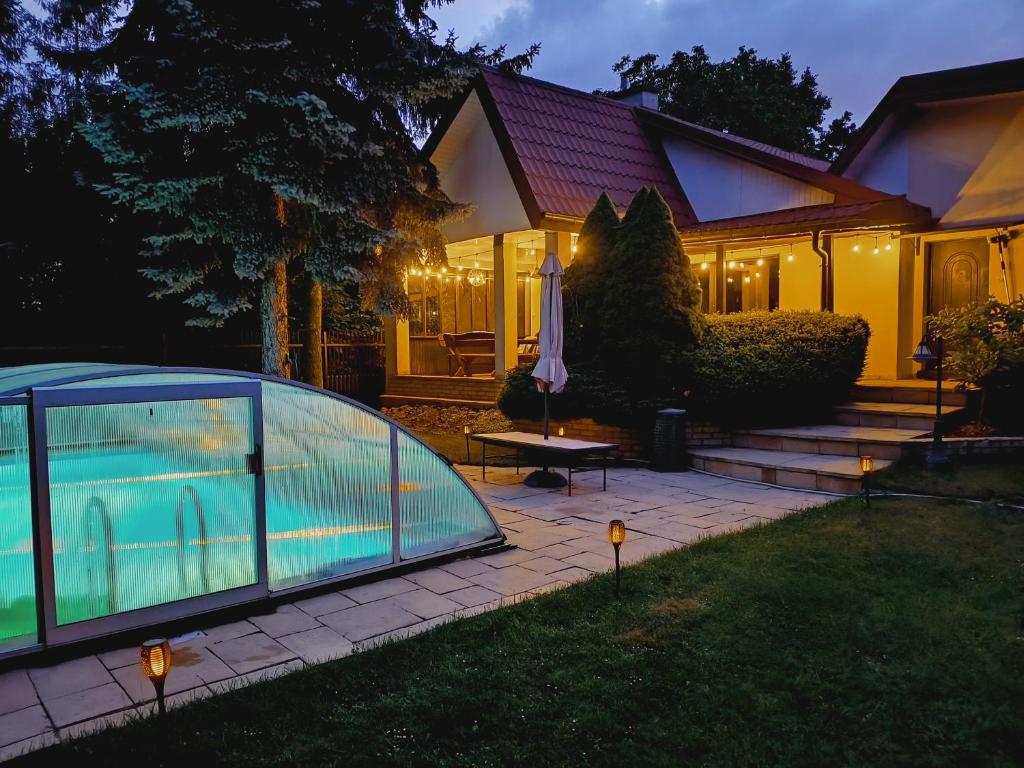 a house with a swimming pool in the yard at Domek Olmonty in Białystok