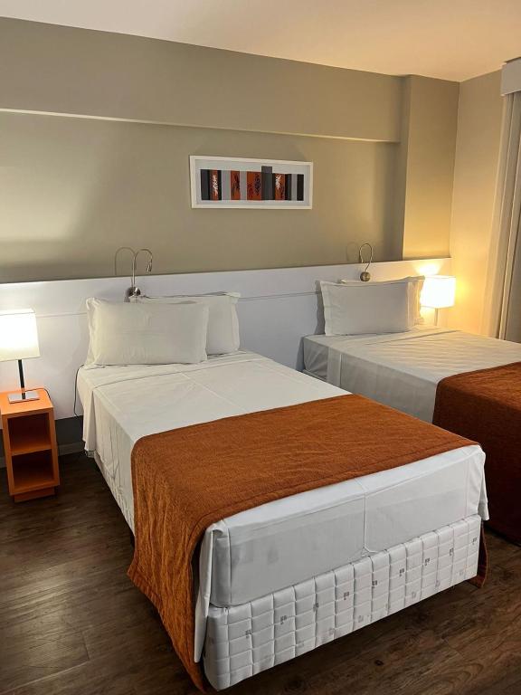 Cama ou camas em um quarto em Intercity BH Expo
