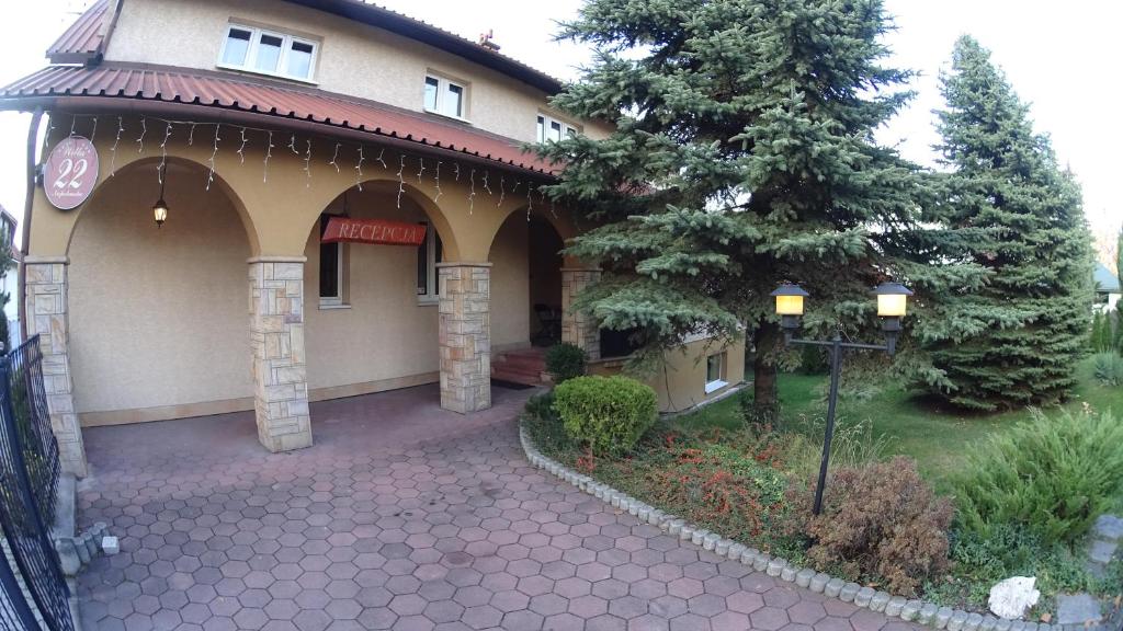 a building with a tree in front of it at Willa Relaks in Wieliczka