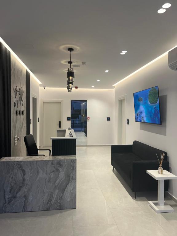a lobby with a black couch and a table at Adele Hotel Ksamil in Ksamil