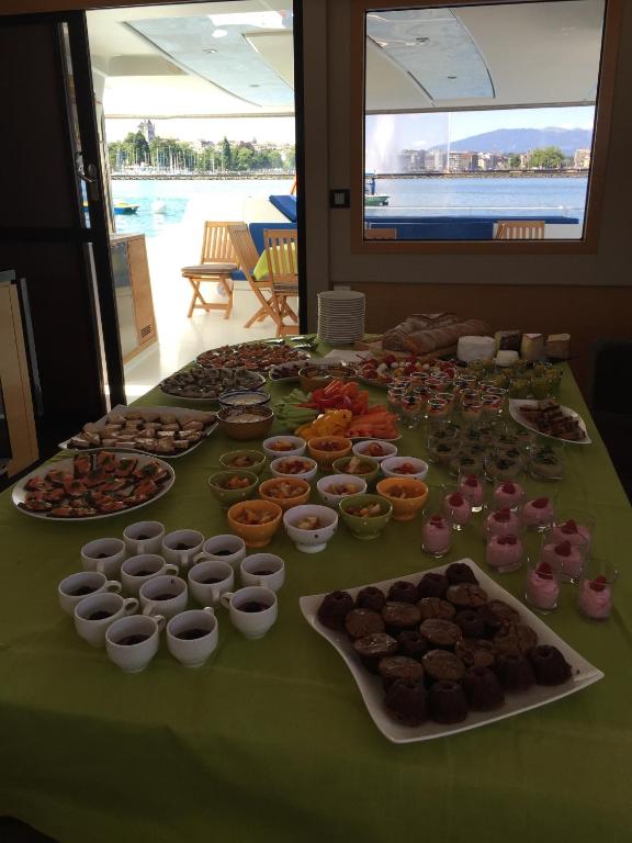 a table with many different types of food on it at Floatinn Boat-BnB in Geneva