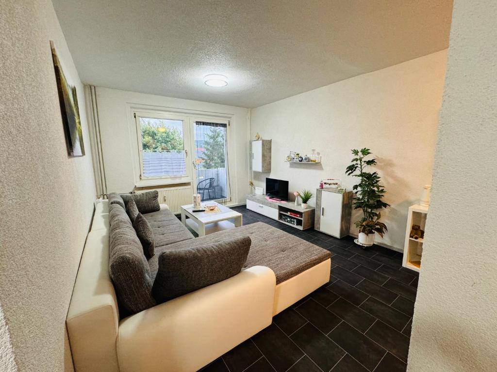 a living room with a couch and a table at Ferienwohnung Heringen in Heringen