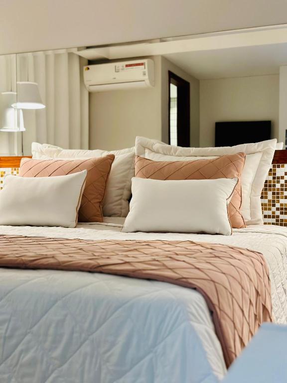 a large bed with two pillows on top of it at Porty Brasil Hotel in Paranaguá