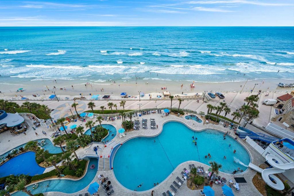 an aerial view of a pool and the beach at Luxury 11th Floor 1 BR Condo Direct Oceanfront Wyndham Ocean Walk Resort Daytona Beach | 1105 in Daytona Beach