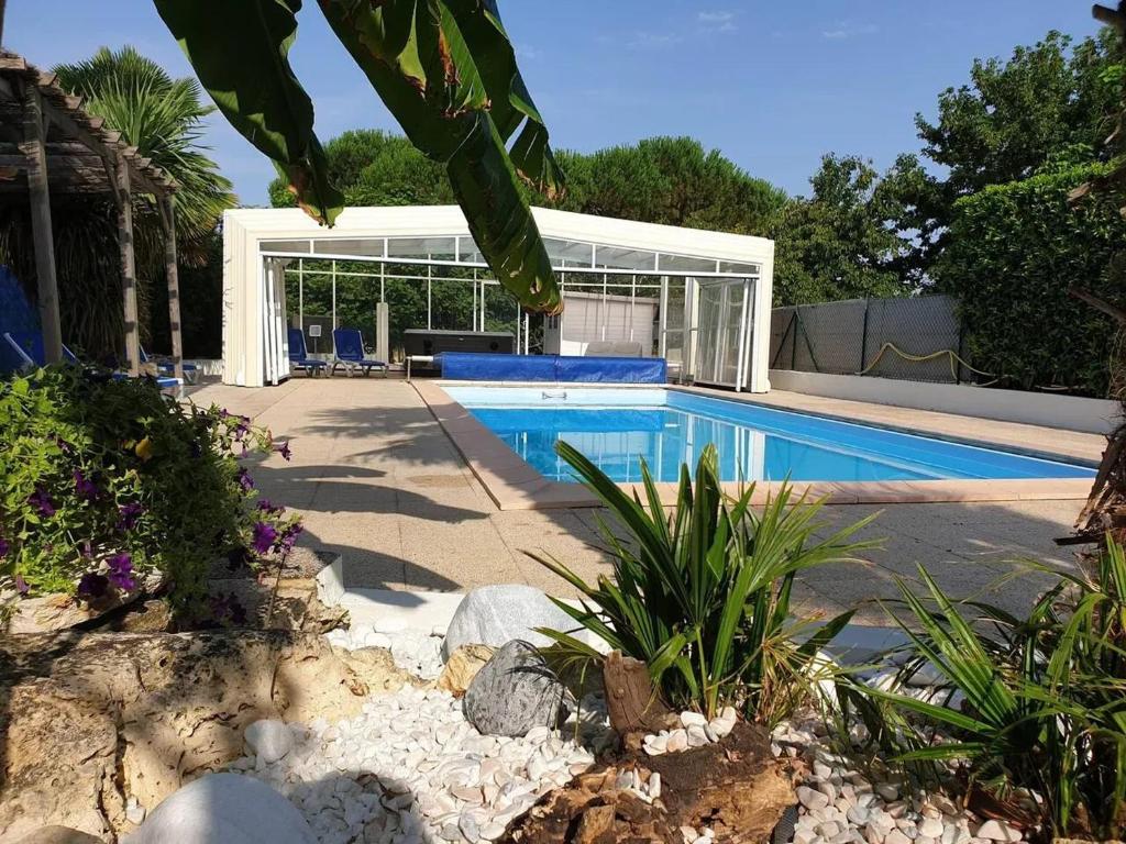a swimming pool in a backyard with a house at Maison de charme à Meursac avec piscine in Meursac